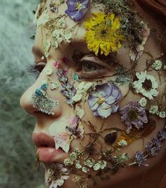 a woman with flowers all over her face