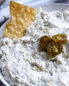 a white bowl filled with dip and chips