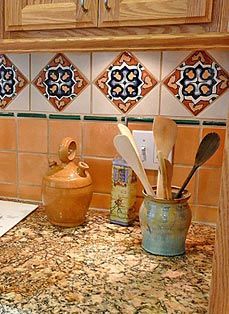 a kitchen counter with utensils in an old can and tile backsplash