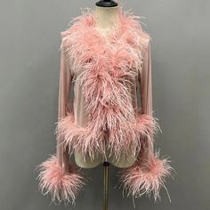 a mannequin with pink feathers on it