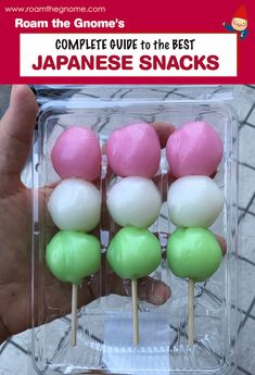 someone is holding up some colorful lollipops in a clear box with the title, complete guide to the best japanese snacks