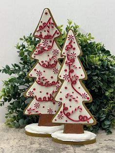 two decorated christmas trees sitting on top of a table