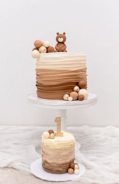 two tiered cake with teddy bears on top