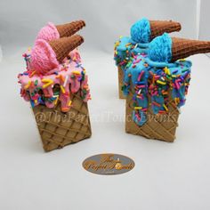 two ice cream cones with sprinkles and toppings