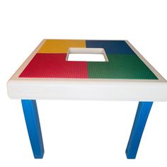 a multicolored table with blue legs and a square shaped object on the top