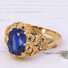 A fine Victorian sapphire ring. The sapphire - certified as originating from Ceylon (Sri Lanka) - is a deep, vivid blue with clear flashes of bright azure. The stone is set in an 18k yellow gold Victorian mount featuring intricate and ornate scroll work and foliate detailing in the gallery and down the shoulders. Accompanied by a sapphire report from The Gem & Pearl Laboratory stating the sapphire is Sri Lankan (Ceylon) in origin. Cut - Cushion cut. Colour - Blue. Clarity - Eye clean. Carat - Ap Gatsby Jewelry, Ceylon Sapphire Ring, Ceylon Sri Lanka, Sapphire Solitaire Ring, Scroll Work, Sapphire Solitaire, Ceylon Sapphire, Cushion Cut, Solitaire Ring