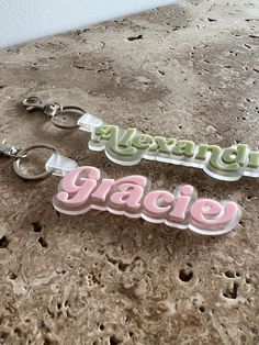 two keychains with the words happy, peace and merry written on them