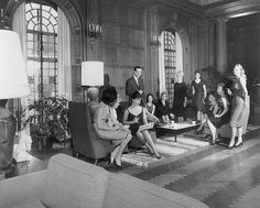 black and white photograph of people in a living room