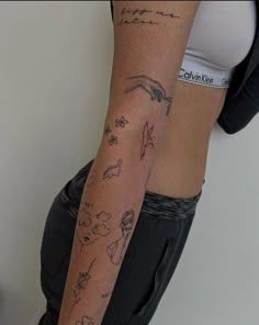 a woman's arm with tattoos on it