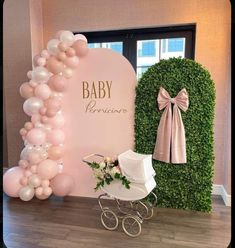 a baby shower is set up with balloons and a stroller for the baby to sit in