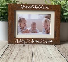 a wooden frame with the words, we love you mommy and two babies on it