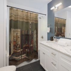 a bathroom with a shower curtain that has a painting on it