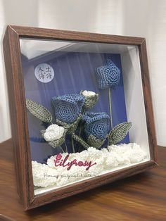 a wooden frame with some flowers in it