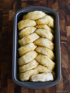 a pan filled with food on top of a wooden table