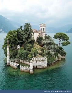 an island in the middle of water surrounded by trees