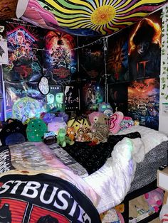 a bed room with a neatly made bed and lots of posters on the wall above it