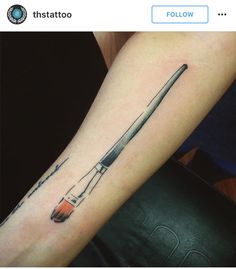 a tattoo on the arm of a person with a paintbrush