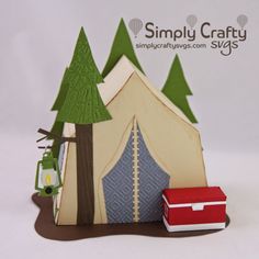 an origami camper and his tent with trees on the side, sitting in front of a white background