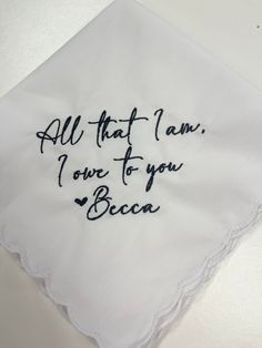 an embroidered handkerchief with the words all that i am, i love to you beca