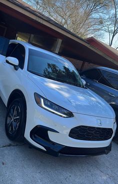 a white car parked in front of a house