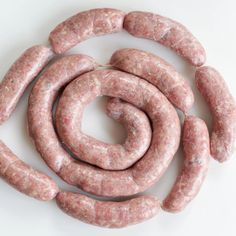 several sausages laid out on a white surface