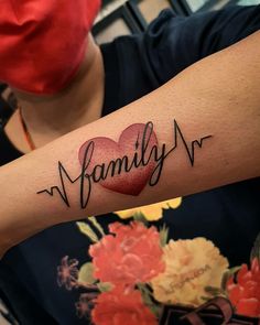 a woman's arm with the word family written on it and a heart in the middle