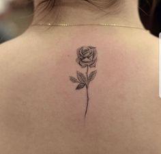 a woman with a rose tattoo on her back