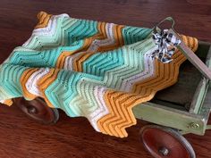 a baby blanket sitting on top of a wooden wagon