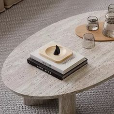 a coffee table with books and glasses on it