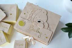 baby shower gift set with teddy bear and gold glitters on the packaging next to it