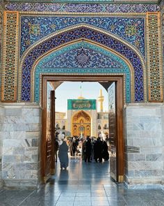 the entrance to an ornate building with blue and gold tiles on it's walls