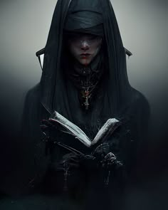 a woman wearing a black hood and holding an open book in her hands while standing in the dark