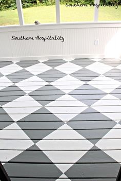 the porch is painted with black and white checkered tile