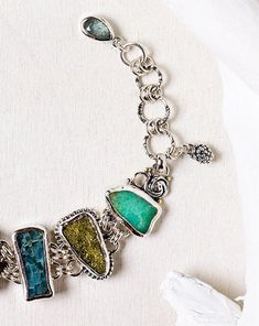 "Raw Stone Bracelet, Silver Jewelry, Hand Cut Stone Bracelet This is an enchanting multi gemstone bracelet with a variety of green and blue gemstones. Bohemian bracelet with a touch of ethnic motifs resulting in a pretty jewelry piece that can be used on many occasions. This is a handmade piece, and is the only one of its kind. Each stone in these bracelets are individually hand cut so that each is a one of a kind bracelet. \"I believe that objects made with love, care, and good materials bring Raw Stone Bracelet, Green Gemstone Bracelet, Multi Gemstone Bracelet, Ethnic Motifs, Fine Silver Jewelry, Bohemian Bracelets, Pretty Jewelry, Bracelet Sterling Silver, Green Gemstones