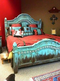 a bed room with a neatly made bed and red walls