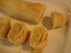 some food that is on a white plate and has been cut in half to show it's contents