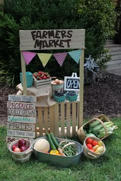 a wooden chair sitting on top of a lush green field filled with fruit and vegetables