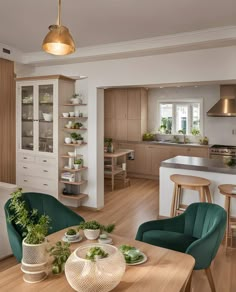 an open concept kitchen and dining area with wood flooring, white walls and cabinets