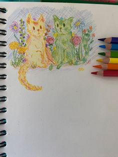 a drawing of two cats sitting next to each other with colored pencils in front of them