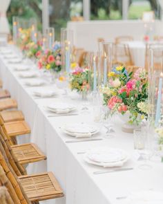 a long table is set with flowers and candles