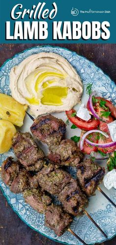 grilled lamb kabobs on a blue and white plate