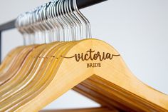 a wooden hanger with the name victoria bride on it