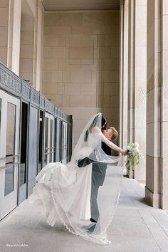 the bride and groom are posing for pictures in front of an entrance to their wedding ceremony