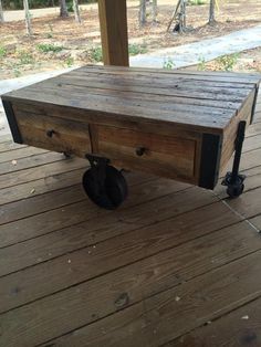 a wooden table sitting on top of a wooden deck