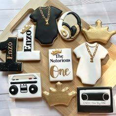 decorated cookies are arranged on a cutting board with the words'the victorious one'in gold, black and white