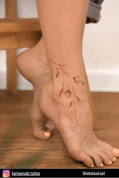 a woman's foot with a flower tattoo on it