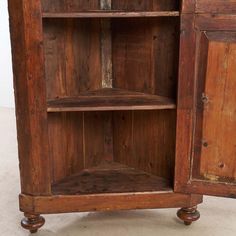 an old wooden cabinet with two doors and shelves