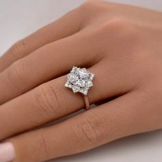 a woman's hand with a diamond ring on it