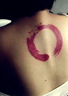 a woman with a red circle tattoo on her back