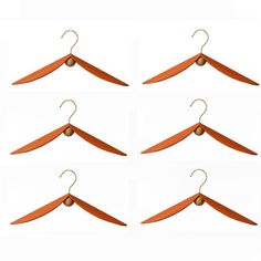 six orange hangers are shown in four different positions, each with one hanging on the other